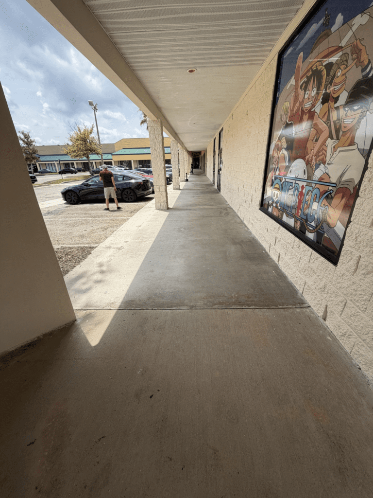 Covered concrete walkway after commercial pressure washing in Orlando