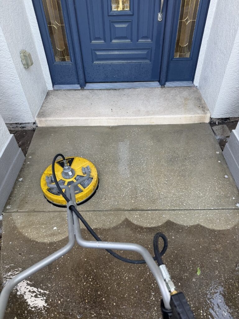 Professional pressure washing equipment at an Orlando home entryway