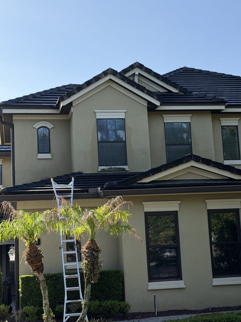 Crew soft washing a two-story home in Orlando